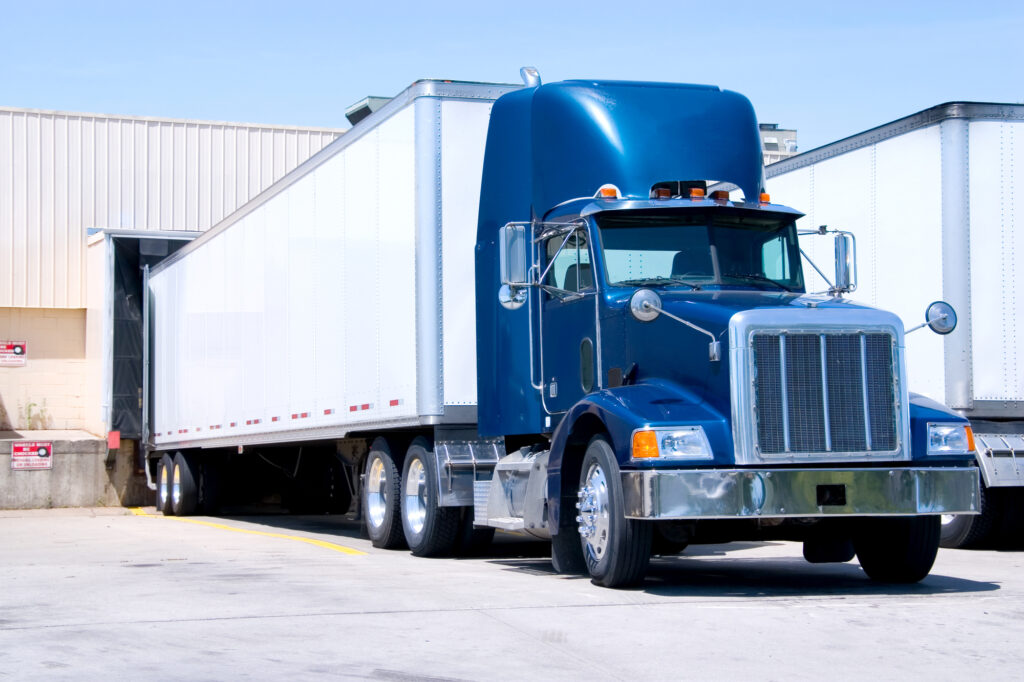 Blue and White Truck Loading at a Warehouse