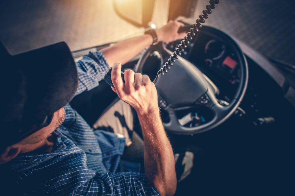 Truck Driver Making Conversation with Other Through CB Radio.